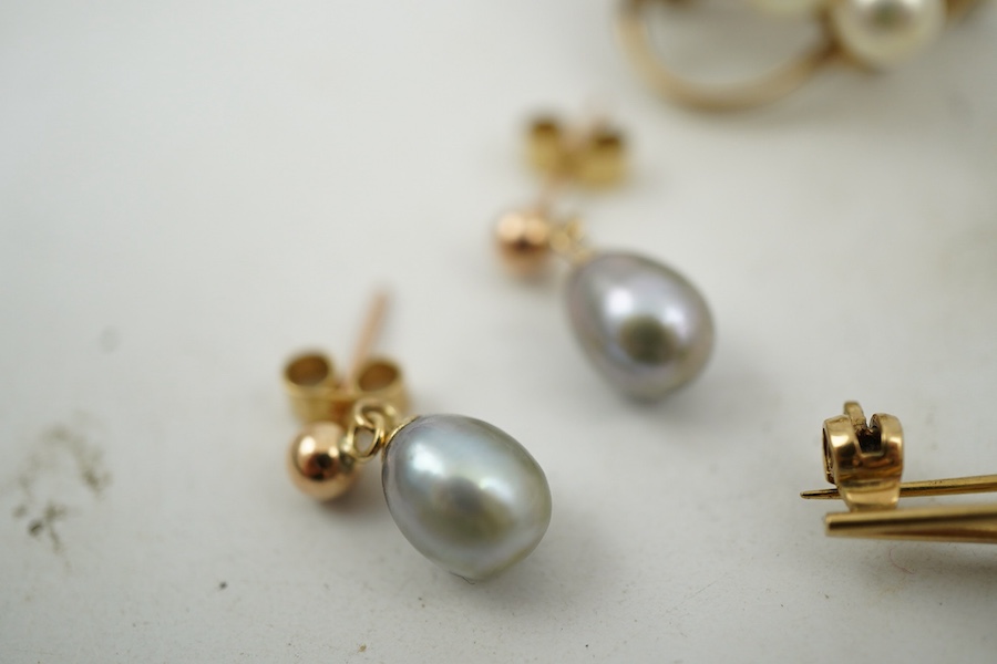 A group of cultured pearl jewels, comprising: two pairs of cultured pearl drop earrings, longest 3cm, mounted in gold; and two cultured pearl brooches mounted in 9ct gold, longest 4.1cm, British hallmarks, combined gross